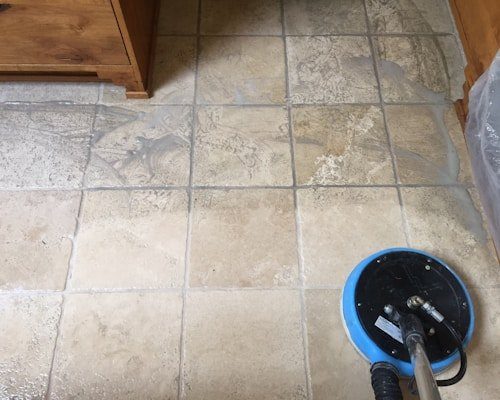 Floor scrubbing machine on tiled floor